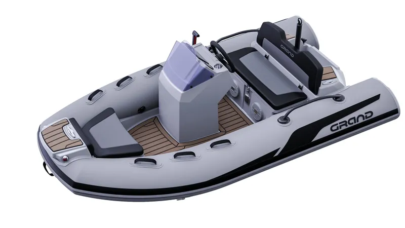 Slide: The Image of 2025 Grand Inflatables G380 boat, sleek design, gray with black accents, modern seating, and console. - 9