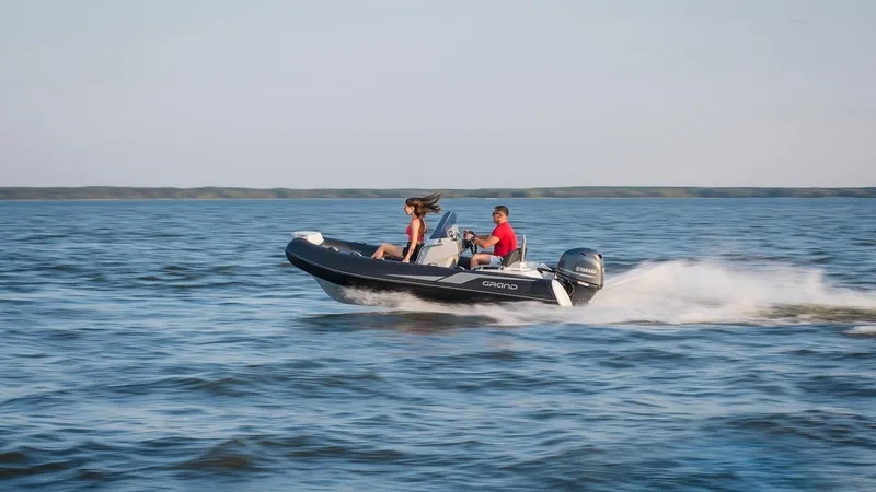 Slide: The Image of 2025 Grand Inflatables G420 boat speeding on open water. - 20