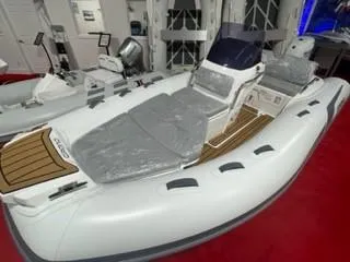 Slide: The Image of 2025 Grand Inflatables G420 boat displayed indoors on red carpet. - 5