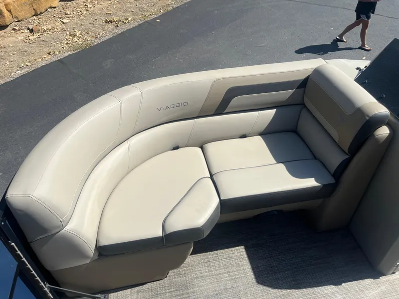 Slide: The Image of 2022 Viaggio Lago S boat seating with beige upholstery, outdoor setting. - 12
