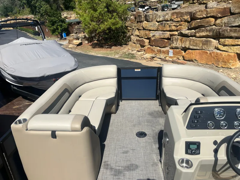 Slide: The Image of 2022 Viaggio Lago S pontoon boat with beige seating and modern dashboard. - 13