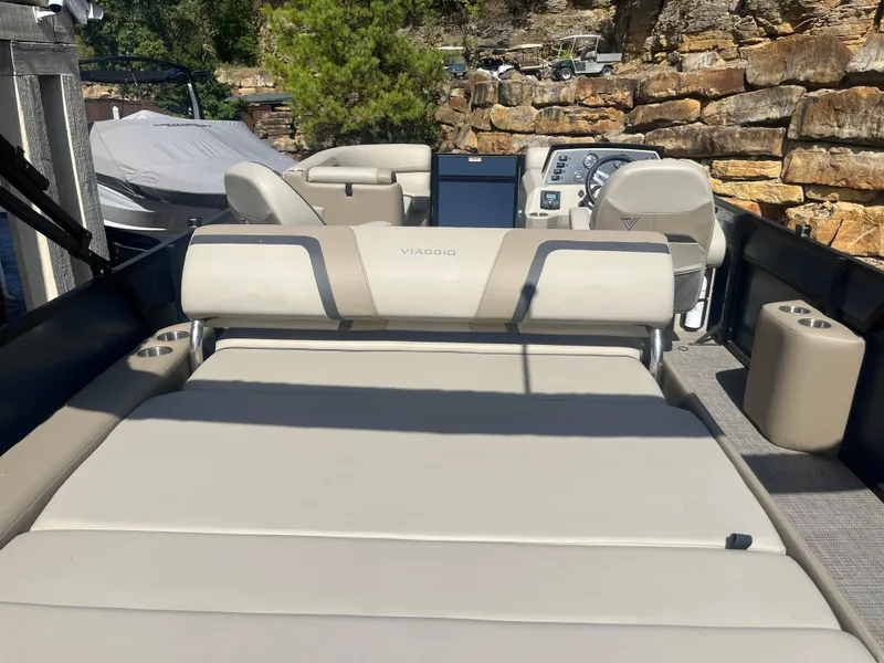 Slide: The Image of 2022 Viaggio Lago S boat interior with beige seating and control panel. - 16