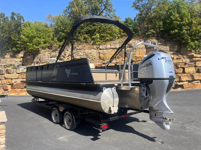 Slide: The Image of 2022 Viaggio Lago S pontoon boat with Honda 250 engine on trailer. - 2