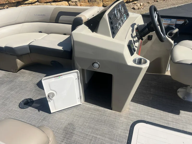 Slide: The Image of 2022 Viaggio Lago S boat interior with steering console and seating area. - 22
