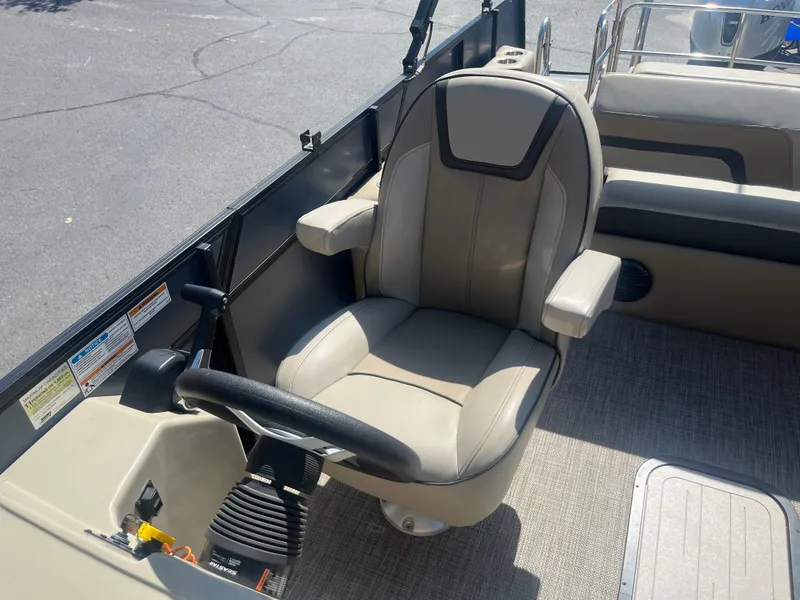 Slide: The Image of Captain's chair on 2022 Viaggio Lago S boat, featuring beige upholstery and steering wheel. - 24