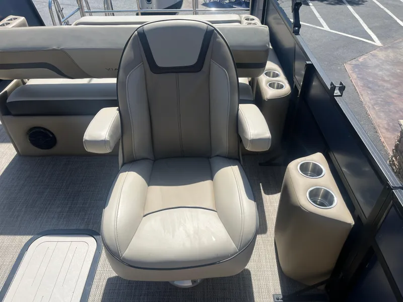 Slide: The Image of Captain's chair on 2022 Viaggio Lago S boat with cup holders and beige upholstery. - 25