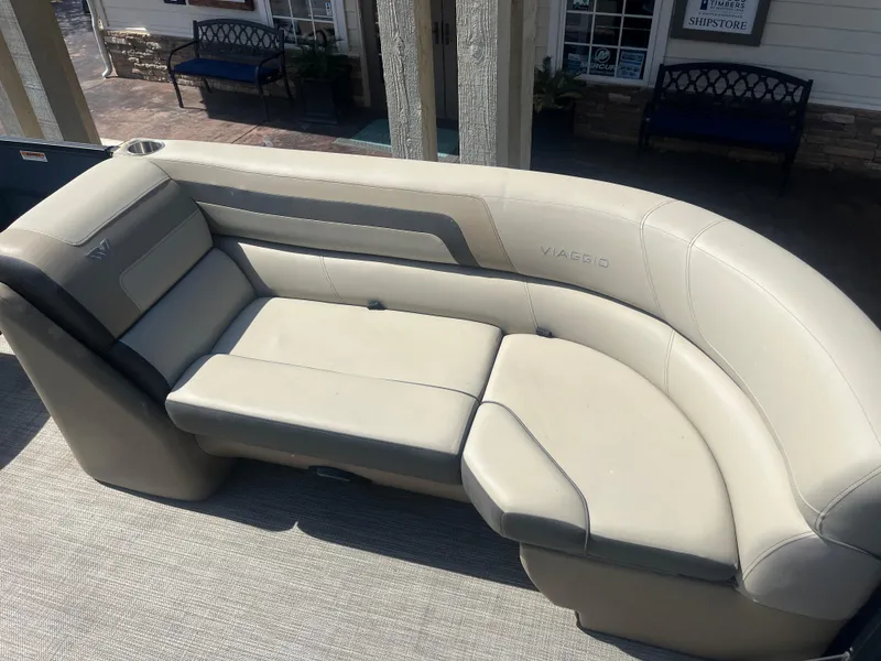 Slide: The Image of 2022 Viaggio Lago S boat seating with beige upholstery, outdoor setting. - 26