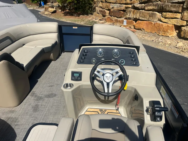 Slide: The Image of 2022 Viaggio Lago S boat interior with steering wheel and seating area. - 29