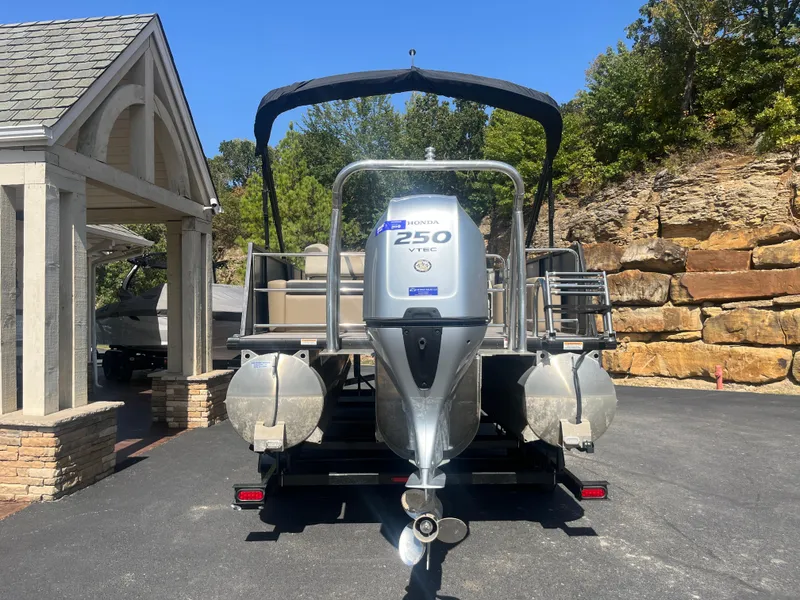 Slide: The Image of 2022 Viaggio Lago S pontoon boat with Honda 250 engine, parked outdoors. - 6