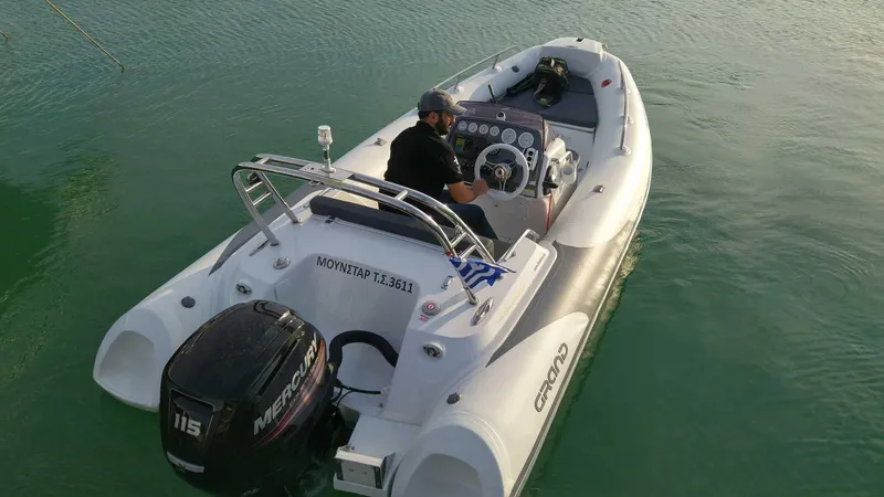 Slide: The Image of 2025 Grand Inflatables G500 boat with Mercury engine on calm water. - 3
