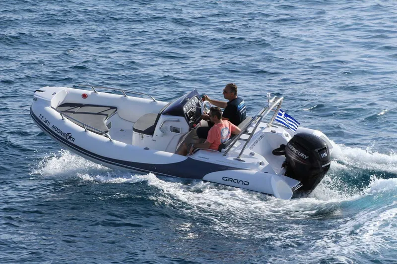 Slide: The Image of 2025 Grand Inflatables G500 boat cruising on open water with passengers. - 6