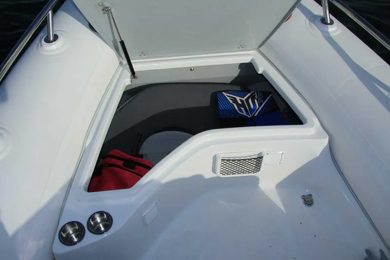 Slide: The Image of 2025 Grand Inflatables G500 boat storage compartment with open hatch and visible gear. - 8