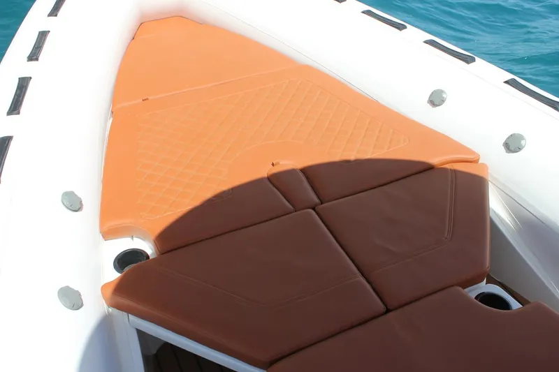 Slide: The Image of Tiger Marine 740 PL 2025 boat deck with cushioned seating and orange mat. - 10