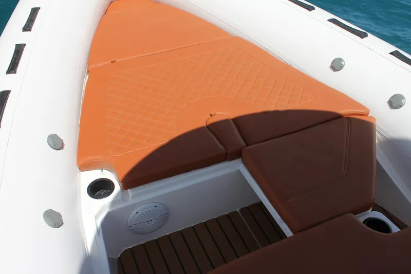 Slide: The Image of 2025 Tiger Marine 740 PL boat interior with orange cushioned seating and white hull. - 11