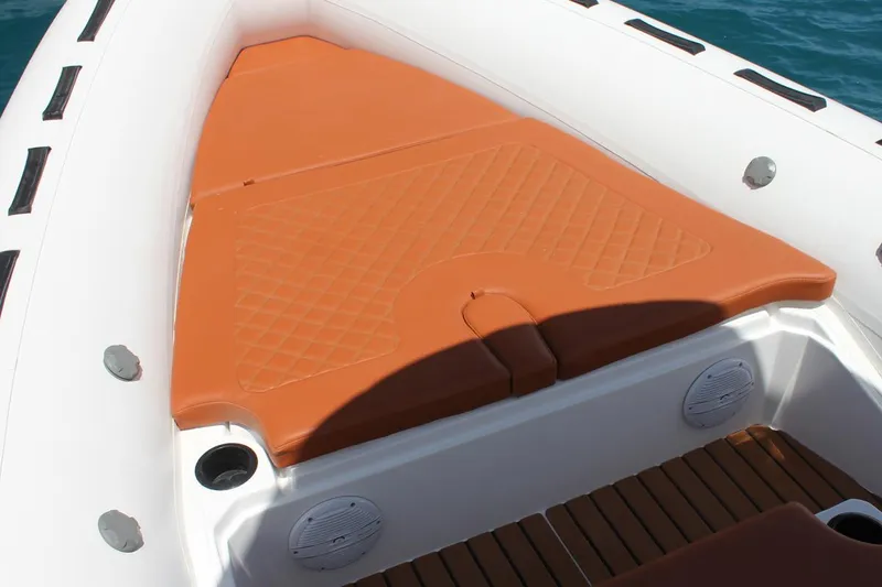 Slide: The Image of 2025 Tiger Marine 740 PL boat with orange cushioned seating and teak flooring. - 12