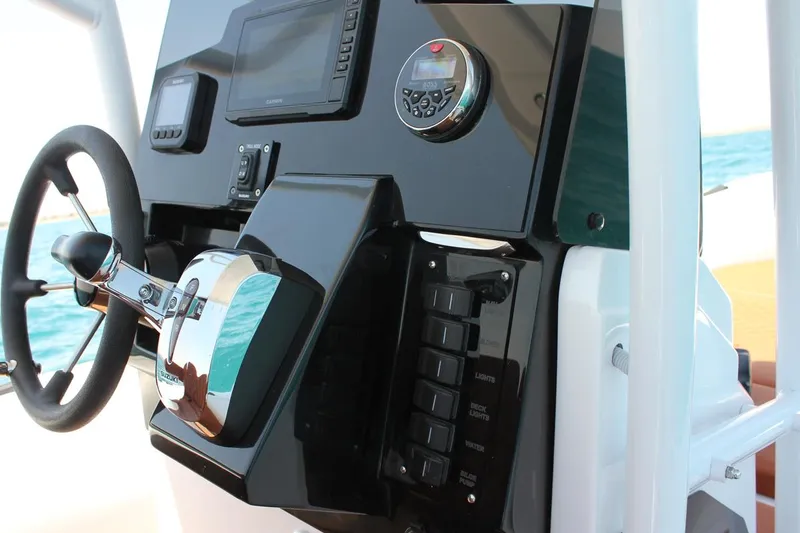 Slide: The Image of 2025 Tiger Marine 740 PL boat dashboard with steering wheel and control panel. - 14