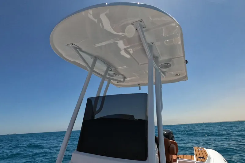 Slide: The Image of 2025 Tiger Marine 740 PL boat with canopy, cruising on open sea under clear blue sky. - 19