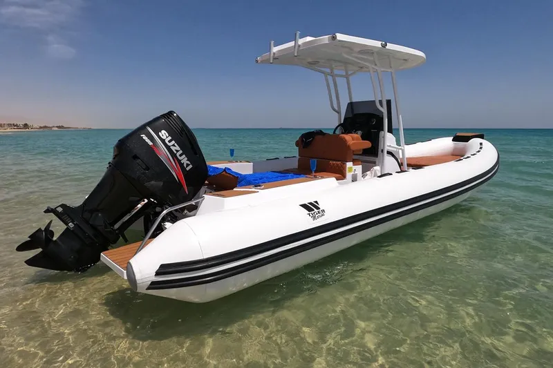 Slide: The Image of 2025 Tiger Marine 740 PL boat with Suzuki engine on clear turquoise water. - 20