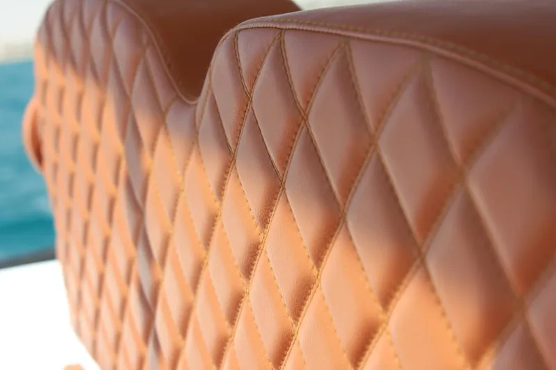 Slide: The Image of Luxurious leather seating on 2025 Tiger Marine 740 PL boat, featuring diamond stitching. - 22