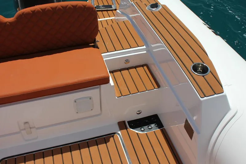 Slide: The Image of Luxurious 2025 Tiger Marine 740 PL boat interior with teak decking and cushioned seating. - 23