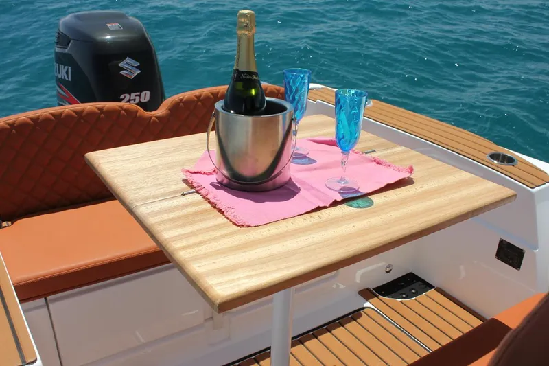 Slide: The Image of Luxury setup on Tiger Marine 740 PL boat, featuring champagne and glasses on a wooden table. - 25