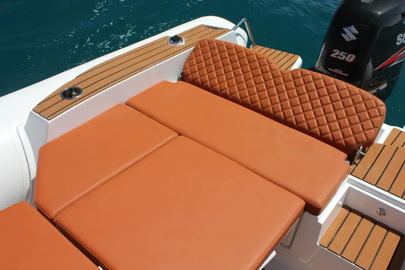 Slide: The Image of Luxurious seating on 2025 Tiger Marine 740 PL boat with quilted upholstery and wooden accents. - 26