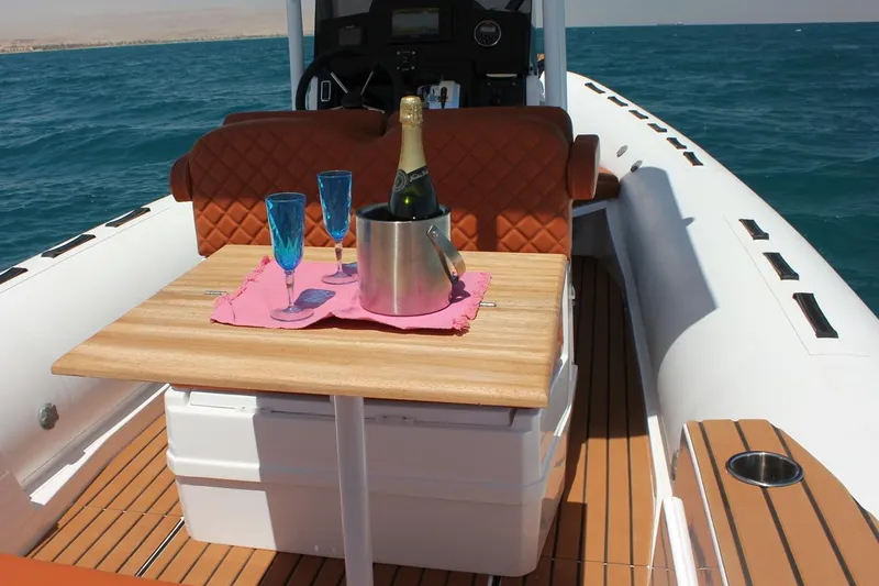 Slide: The Image of Luxury Tiger Marine 740 PL boat with champagne and glasses on a wooden table, 2025 model. - 27