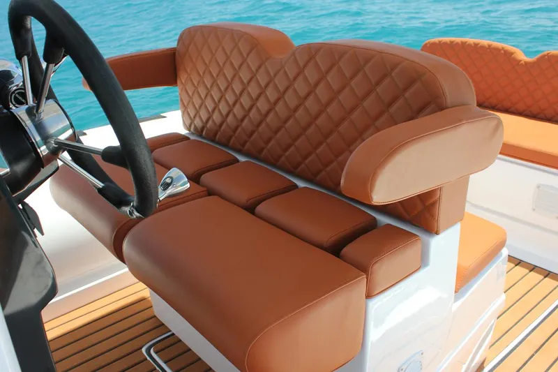 Slide: The Image of Luxurious brown leather seating on 2025 Tiger Marine 740 PL boat, with quilted design. - 28