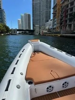 Slide: The Image of 2025 Tiger Marine 740 PL boat cruising in urban waterway with skyscrapers in background. - 32