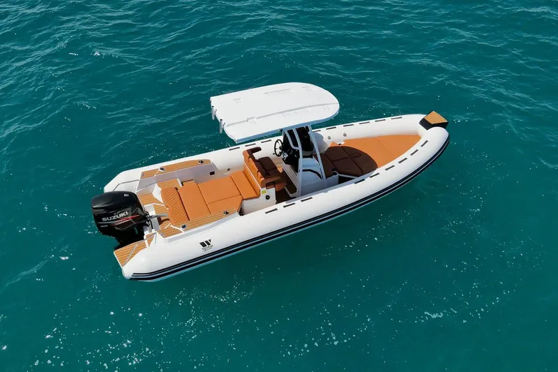 Slide: The Image of 2025 Tiger Marine 740 PL boat on clear blue water, featuring a sleek design and modern amenities. - 4