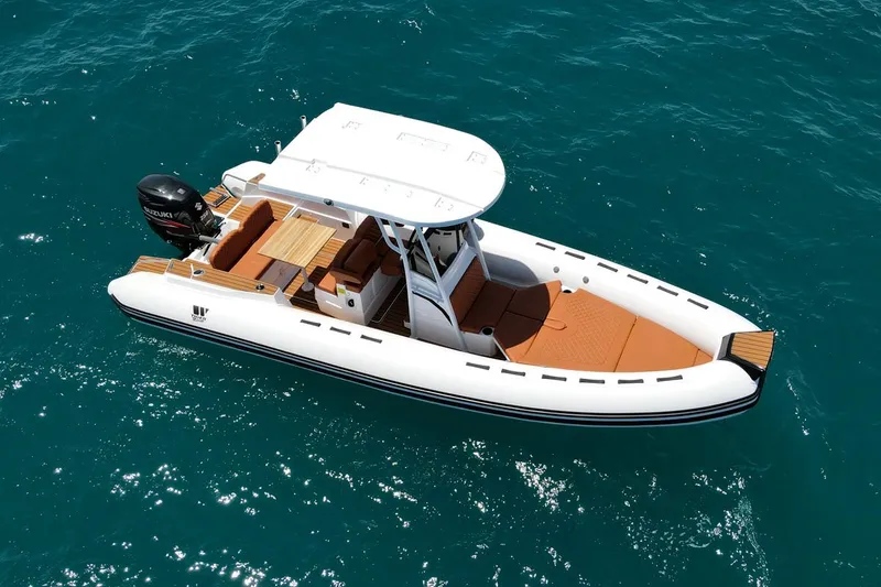Slide: The Image of 2025 Tiger Marine 740 PL boat on clear blue water, featuring sleek design and modern amenities. - 6