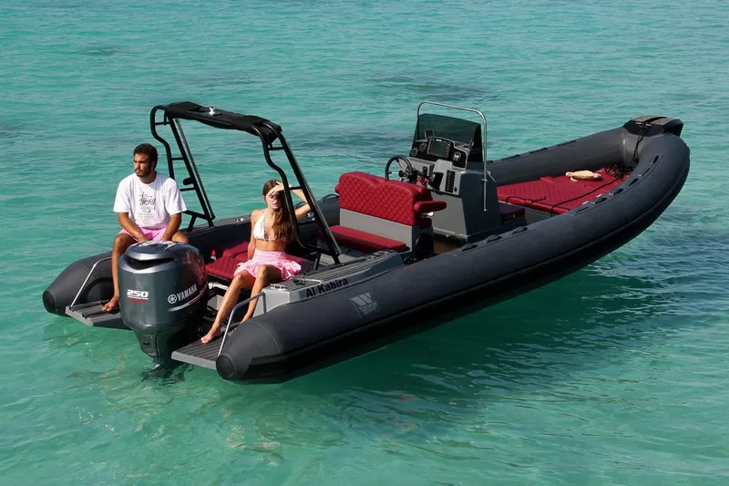 Slide: The Image of 2025 Tiger Marine 740 PL boat on clear turquoise water with two people relaxing onboard. - 7