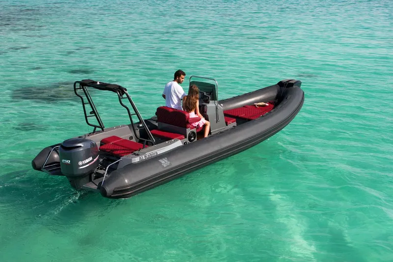 Slide: The Image of 2025 Tiger Marine 740 PL boat cruising on clear turquoise water. - 8