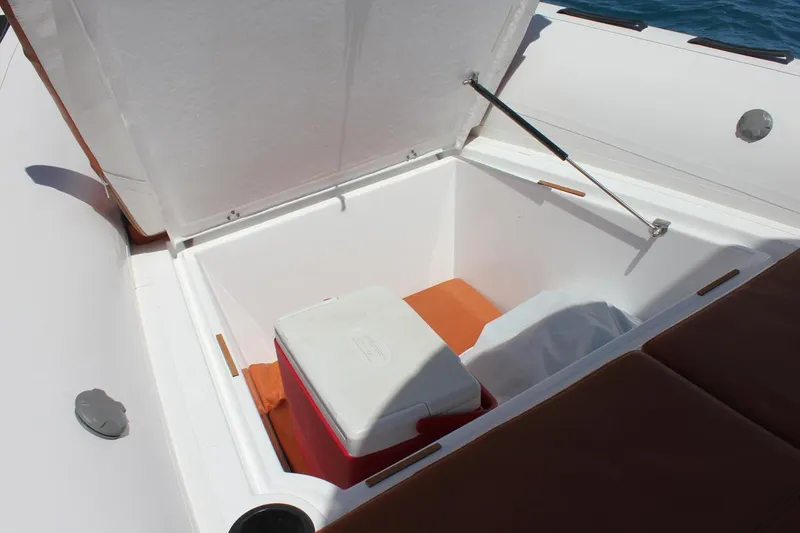 Slide: The Image of Open storage compartment on 2025 Tiger Marine 740 PL boat with cooler inside. - 9