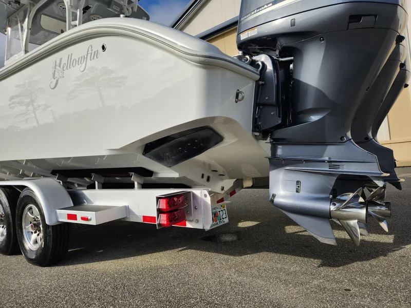 Slide: The Image of 2017 Yellowfin 34 Offshore boat with dual outboard motors on a trailer. - 13