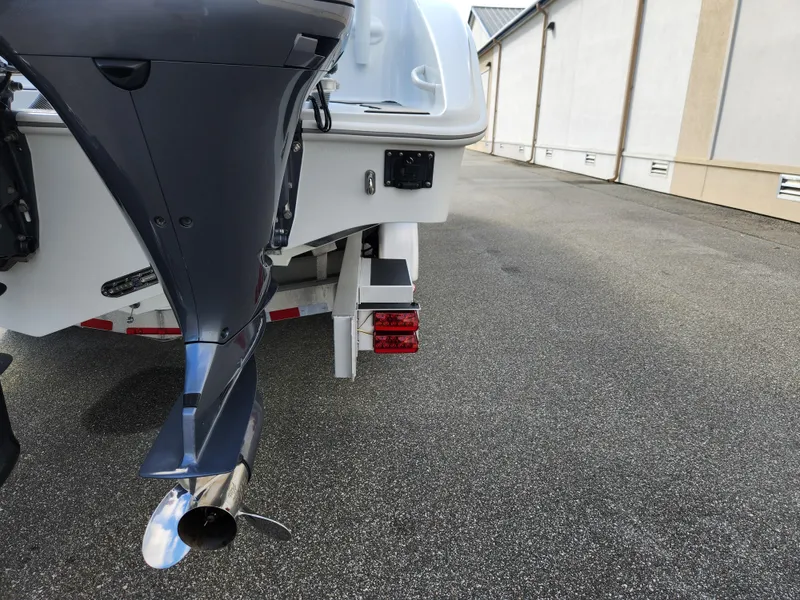 Slide: The Image of 2017 Yellowfin 34 Offshore boat, rear view with outboard motor, parked on pavement. - 15