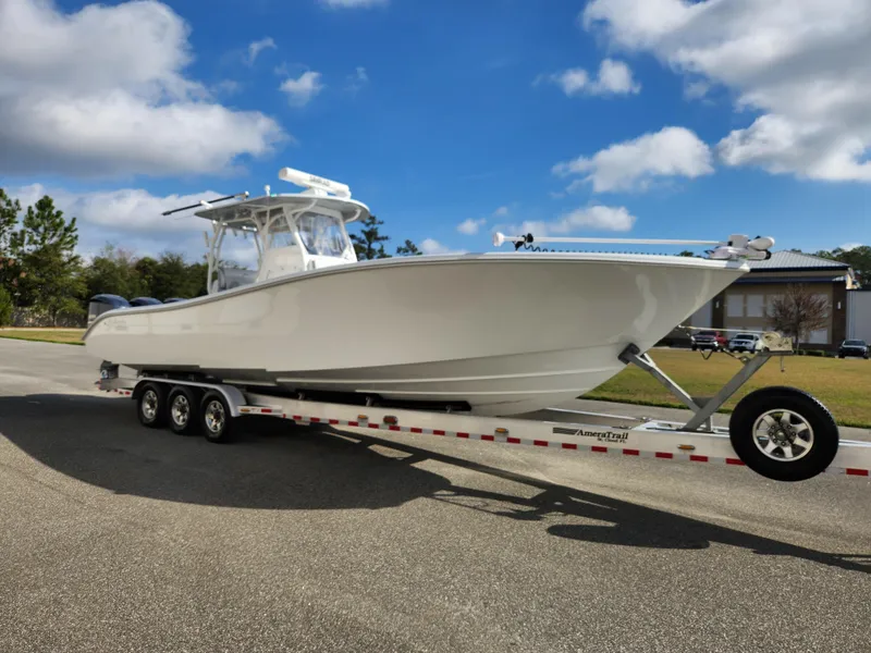 Slide: The Image of 2017 Yellowfin 34 Offshore boat on trailer under blue sky. - 2