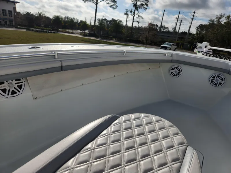 Slide: The Image of 2017 Yellowfin 34 Offshore boat interior with quilted seating and speakers. - 21