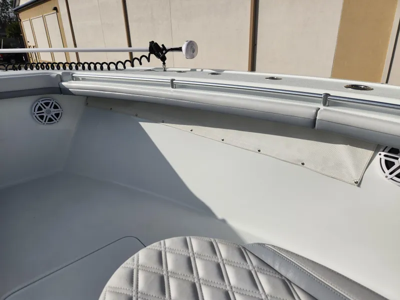 Slide: The Image of 2017 Yellowfin 34 Offshore boat interior with white seating and speakers. - 22