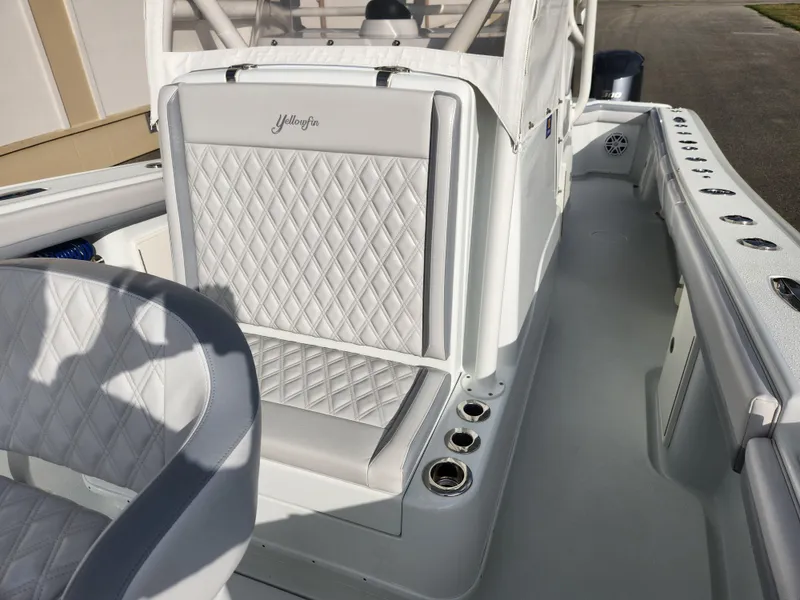 Slide: The Image of 2017 Yellowfin 34 Offshore boat interior with diamond-stitched seating and rod holders. - 27