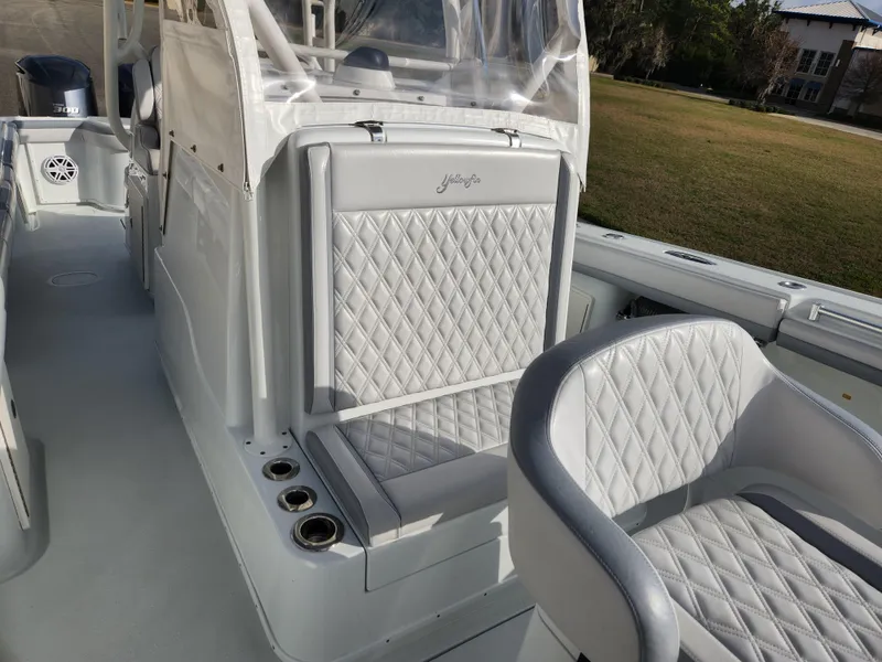 Slide: The Image of 2017 Yellowfin 34 Offshore boat interior with quilted seating and cup holders. - 28