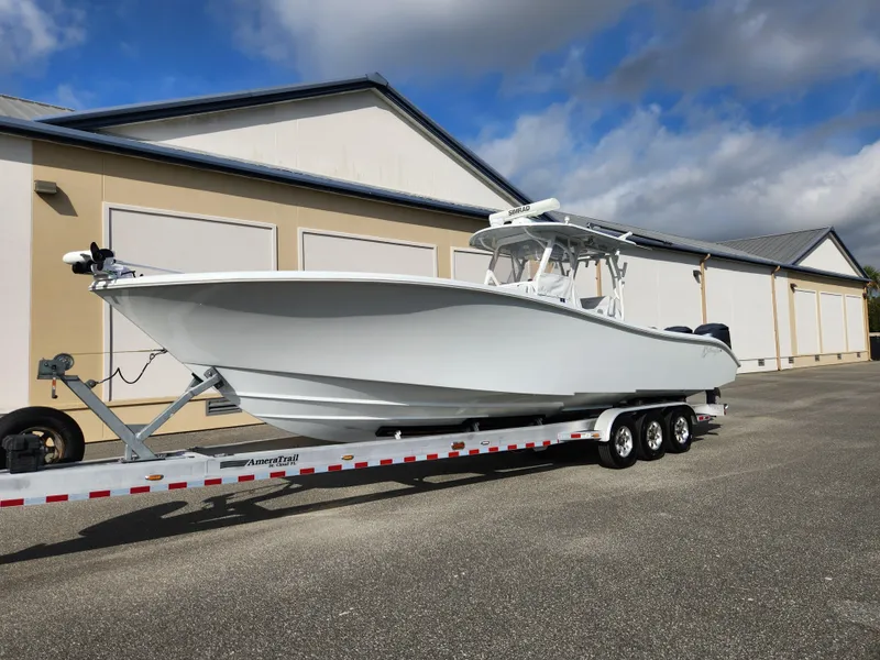 Slide: The Image of 2017 Yellowfin 34 Offshore boat on trailer, parked outside a warehouse. - 3