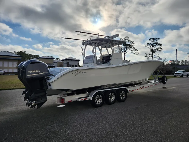 Slide: The Image of 2017 Yellowfin 34 Offshore boat on trailer with Yamaha engines, parked outdoors. - 4