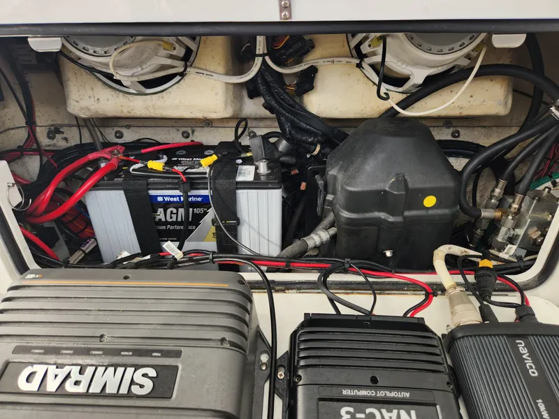Slide: The Image of 2017 Yellowfin 34 Offshore boat engine compartment with batteries and wiring. - 42