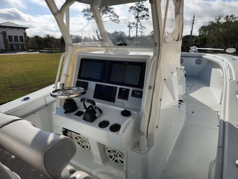 Slide: The Image of 2017 Yellowfin 34 Offshore boat cockpit with navigation controls and seating. - 49