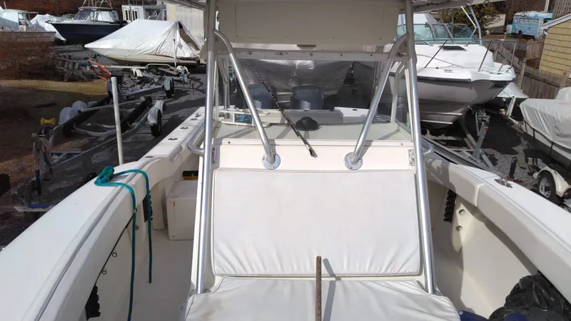Slide: The Image of 1998 Ocean Master 31 CC boat interior with seating and console, docked among other boats. - 10