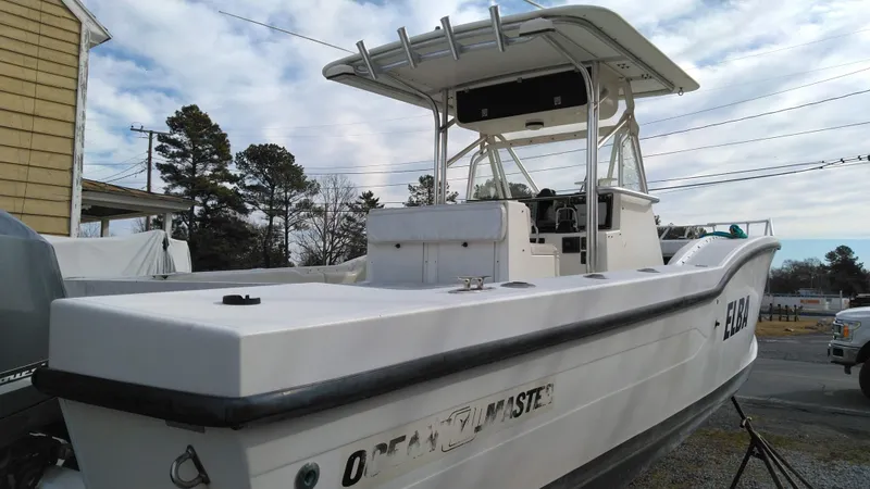 Slide: The Image of 1998 Ocean Master 31 CC boat with T-top, docked outdoors. - 3