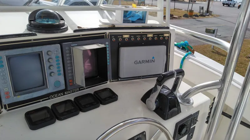 Slide: The Image of 1998 Ocean Master 31 CC boat dashboard with Garmin navigation system and controls. - 5