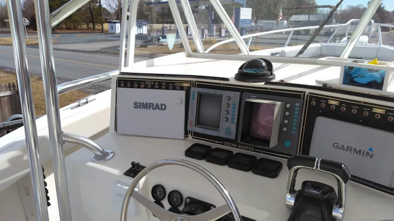 Slide: The Image of 1998 Ocean Master 31 CC boat dashboard with Simrad and Garmin navigation systems. - 6