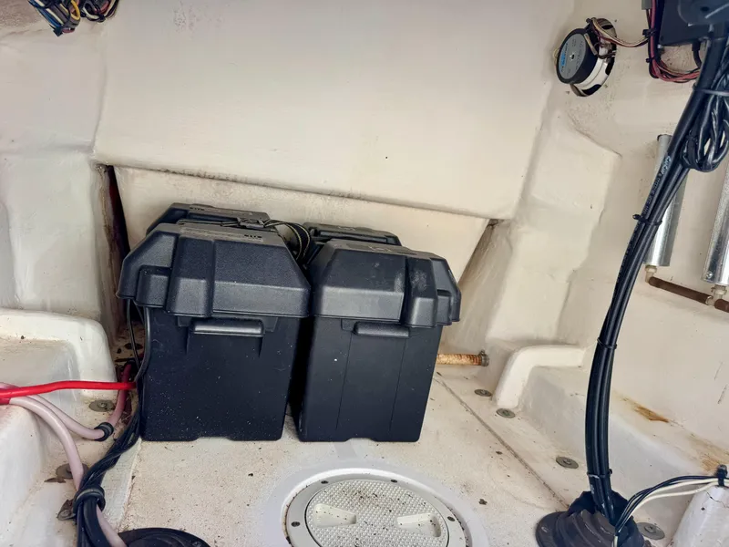 Slide: The Image of 2008 Contender 21 Open boat interior with dual battery boxes and wiring. - 7